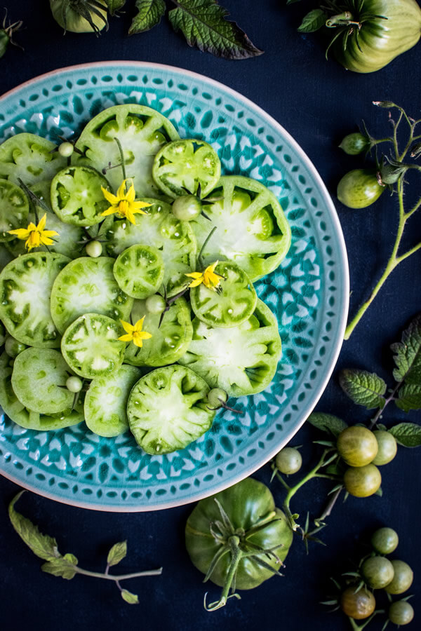 Green tomatoes with edible spring flower vinaigrette